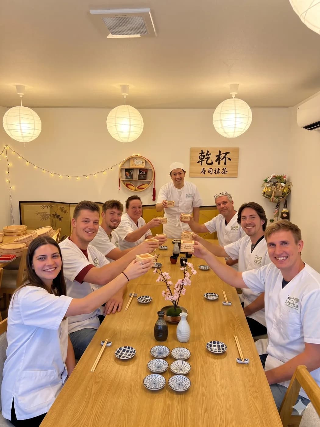 Group toasting with sake at a sushi class